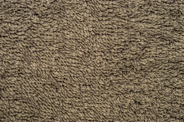 Soft brown towel texture creating relaxing spa background.