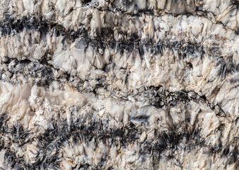 Natural mineral formation displaying intricate patterns found in rocky terrain during daylight