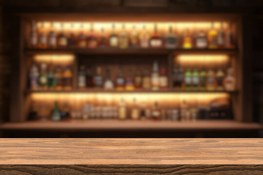 Empty wooden bar counter with defocused background and bottles of restaurant, bar or cafeteria background for your product display