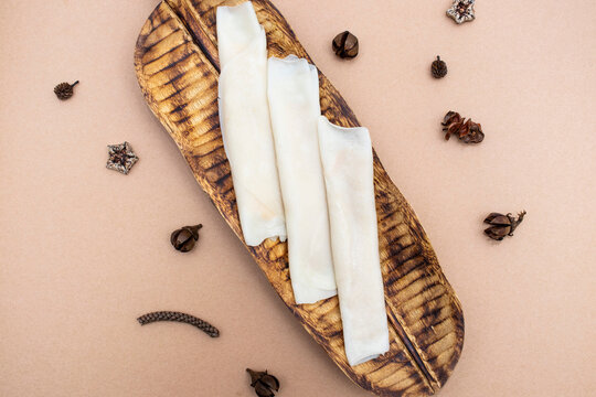 Patishapta served on wooden board isolated on brown background top view of indian, pakistani and bangladeshi food