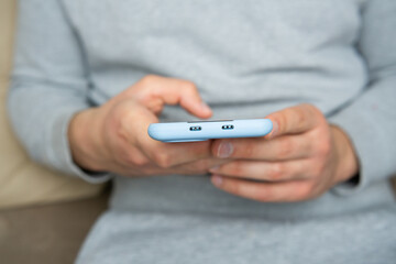 Closeup of Man's hands using smartphone