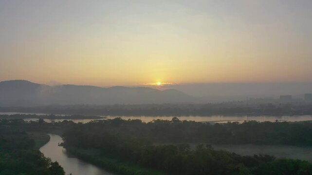 Drone shot showcasing the breathtaking view of the Golden Triangle, where the borders of Thailand, Laos, and Myanmar meet. The scene captures the majestic rivers&mdash;Mekong and Ruak