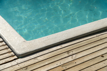 close-up of a pool with shimmering water, reflecting sunlight.