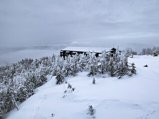 Snow covered trees and a restaurant high on Mount Yokoteyama, Japan