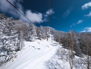 Two person chair lifts at the Shibutoge Yokoteyama ski area in Nagano, Japan