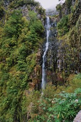 Picturesque Waterfall Cascading Down Lush Green Cliffs