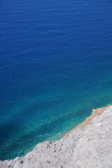 Crystal Clear Ocean Waters by a Rocky Cliff Edge