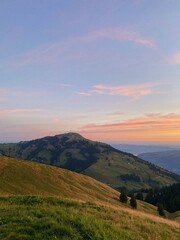 Fototapeta premium Rolling Hills and Vibrant Sunset in the Swiss Countryside