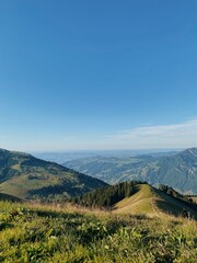 Idyllic Alpine Landscape with Rolling Hills and Clear Blue Sky