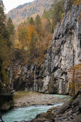 Autumn Foliage and River Flowing Through a Rocky Gorge in Switzerland