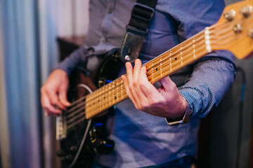 Electric bass guitar player hands, live music