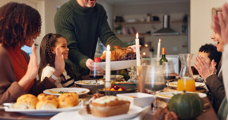 Big family, serving chicken and thanksgiving with children, holiday and food in home. People, applause and festive celebration at dinner party, reunion and gathering for bonding or event on vacation