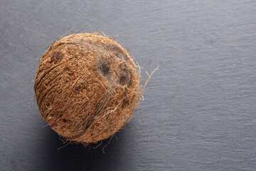 a coconut fruit on a stone surface