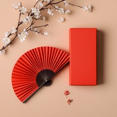 Elegant red fan and decorative box with blossoms on a soft background