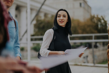 A confident businesswoman walks with colleagues through a cityscape, holding papers. The urban...