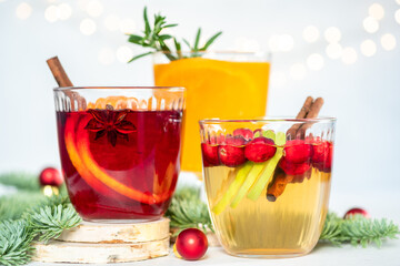 Three glasses of different colored drinks with cinnamon sticks in them