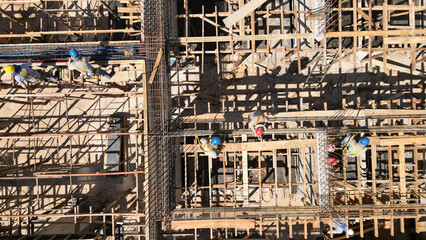 Structure building construction being constructed with business finance and industry. Concrete building.  Men working on construction at construction site