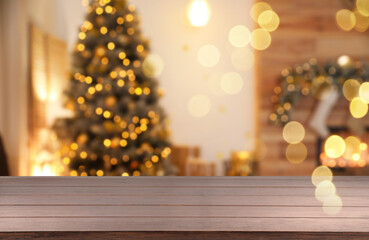 Empty table in room with Christmas tree, bokeh effect