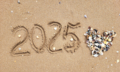 New Year's Eve 2025. Numbers written in the sand next to a pile of shells in the shape of a heart