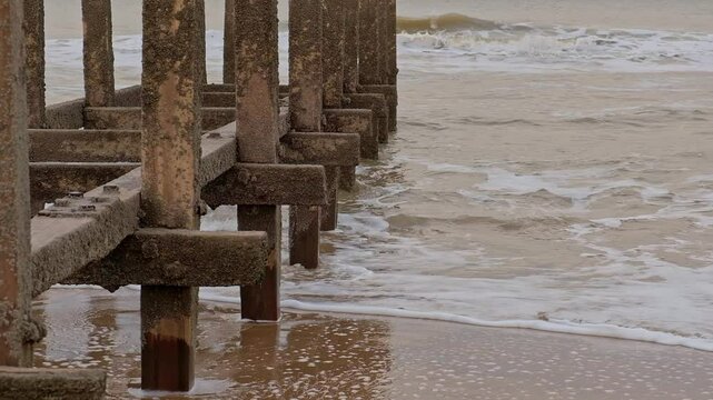 Close up of wooden groynes on the Norfolk coast