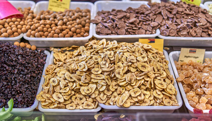 Assorted dried fruits and chocolate candies in market display