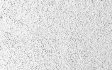 Concrete wall with rough white plaster layer. Front view
