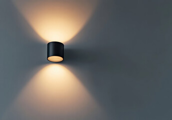 Modern wall light fixture casting warm shadows on gray wall