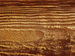 Yellow brown surface texture of river stone, warm background place for text , texture of the sand