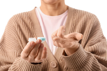 Mature woman with contact lens and case on white background, closeup