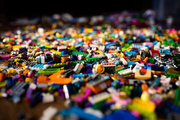 colorful plastic toys, bricks on a floor.