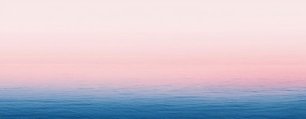 Obraz premium Serene seascape with a gradient of pink and blue hues reflecting the sunrise in calm waters, creating a tranquil and peaceful atmosphere