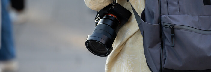 the tourist with his backpack and camera