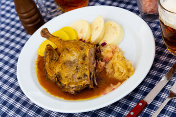 Grilled duck leg quarter with red and white cabbage