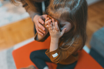 Fototapeta premium A child holds a smartphone, showing curiosity and playfulness in exploring modern technology within a familiar setting, highlighting engagement and discovery.