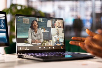 Manager in startup office holding teleconference meeting with employees, doing performance review....
