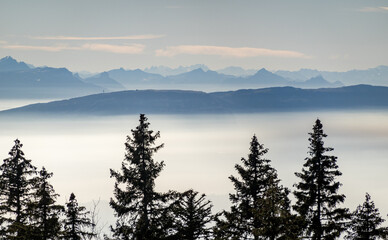 French Alps rising above the mist on Lake Geneva