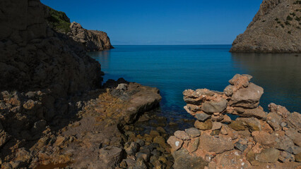 Crystal clear water in Cala Domestica in Sardinia. Drone shot among the heavenly rocks.