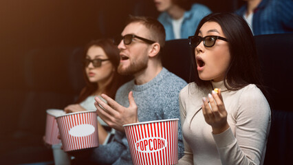 Entertainment and leisure. Shocked audience watching scary movie in cinema