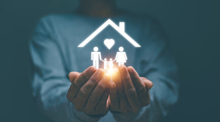 Family life and property insurance concept, Businessman using two hands holding for protect family life and property, Businessman with protective gesture representing the insured family.