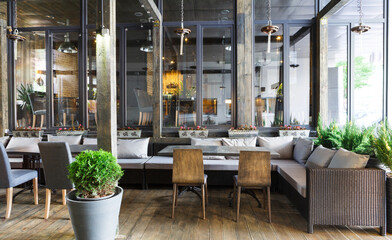 Interior of cozy restaurant. Contemporary design in loft style, modern dining place and bar counter, copy space