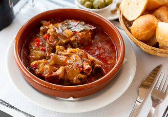Freshly baked pork legs with tomato sauce, popular catalan dish