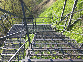 Steel spiral staircase, small perforated steel sheets, steel columns for stairs. descending or ascending stairs. railings and handrails for convenience and safety