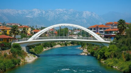 Obraz premium Scenic bridge over a river with mountains backdrop.