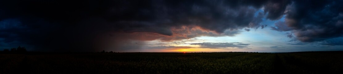 Summer sunset over wheat field. Beautiful sunset sky over countryside