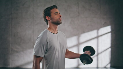 Strong powerlifter lifting weight loft fitness gym closeup. Man pumping biceps
