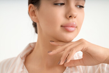 Beautiful young woman with soft lips on white background, closeup