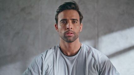 Focused man exercising weight plate in loft studio closeup. Man training hands