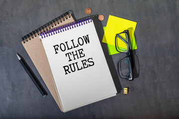 Follow the rules - Businessman holding sign with text.