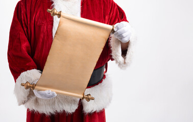 Santa Claus making his list on a scroll and checking it twice for boys and girls Christmas presents for the Holiday season
