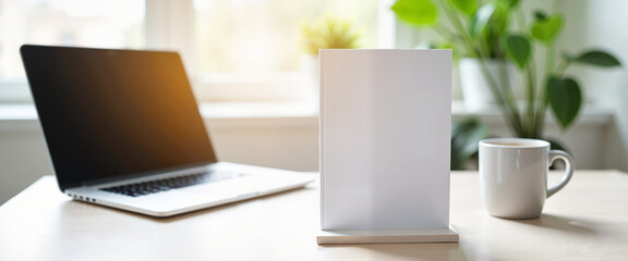 Fototapeta premium Laptop and blank stand on desk with coffee, modern workspace